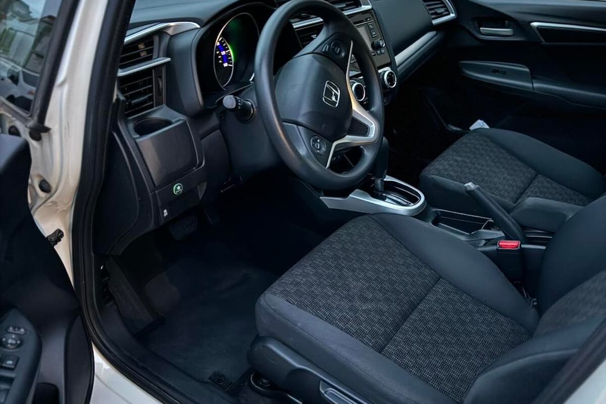 Close-up of fabric seat cleaning during mobile interior detailing in Berkeley, California